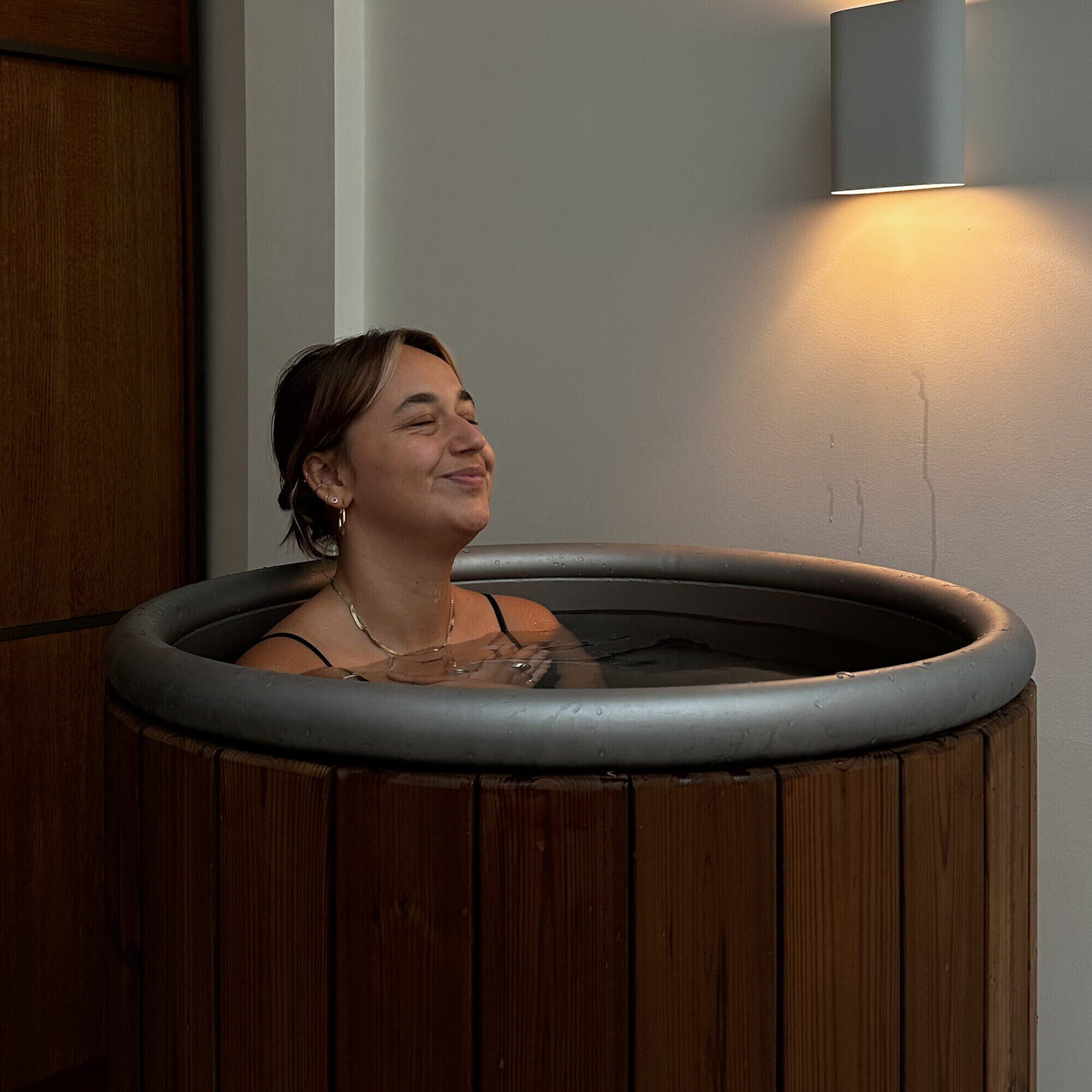 Zonne Perez Raya in the cold plunge barrel at Hima Icebaths Amsterdam